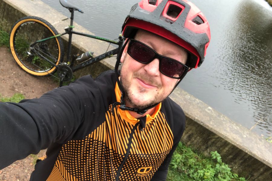 Daniel Smith in cycling kit beside a canal